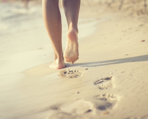 Woman walking on sand beach